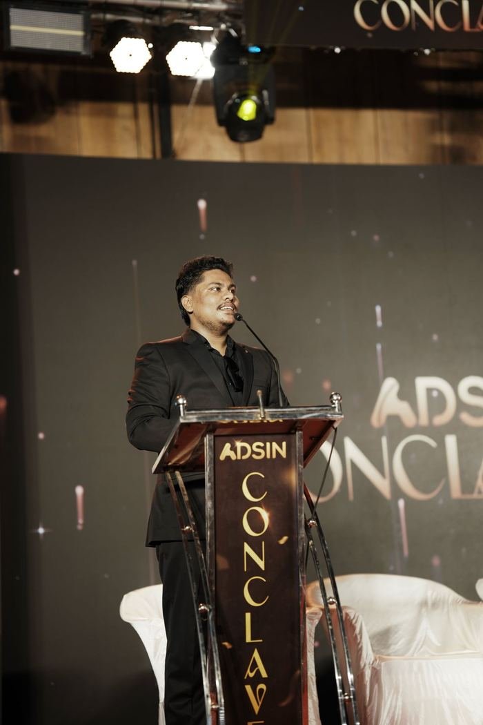 Jasim CP speaking on stage at the Adsin Conclave in Kerala