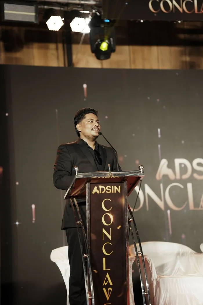 Jasim CP speaking on stage at the Adsin Conclave in Kerala