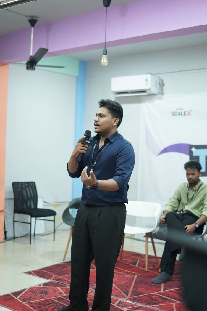 Jasim CP speaking with a microphone at an Adsin team event